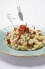Risotto rice with potato and bacon — Stock Photo