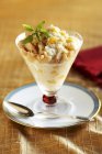 Ginger, tapioca and macadamia nut parfait in glass over plate — Stock Photo
