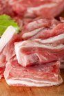 Raw lamb pieces on wooden board — Stock Photo