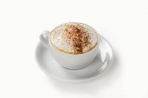Cappuccino in cup and saucer — Stock Photo