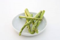 Green asparagus on plate — Stock Photo
