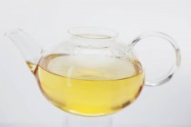 Tea in glass teapot with condensation — Stock Photo