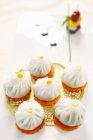 Crystal buns on golden doily and white surface — Stock Photo