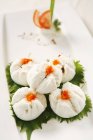 Closeup view of crab dumplings on green leaves — Stock Photo