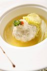 Meatball in broth on white plate — Stock Photo