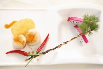 Closeup view of prawn-like composition with dragonfruit, chilli peppers, chip and dill — Stock Photo