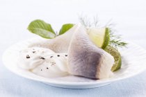 Pickled herring fillets with limes — Stock Photo