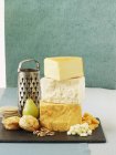 Cheddar cheese on chopping board — Stock Photo