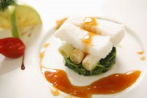 Cod with vegetables  on white plate — Stock Photo