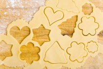 Top  view of biscuit dough with cut-out biscuits — Stock Photo