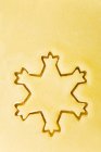 Closeup top view of cut-out snowflake biscuit — Stock Photo