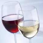 Glasses of red and white wine on table — Stock Photo
