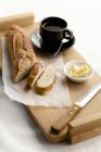 Partially Sliced Baguette with Butter — Stock Photo