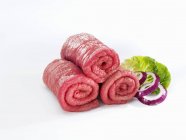Raw beef for roulades with onion rings — Stock Photo