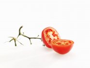 Halved tomato with stalk — Stock Photo