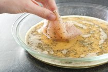 Human hand Dipping Chicken in Egg — Stock Photo