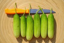 Six cucumbers with knife — Stock Photo