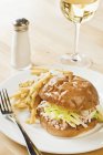 Lobster Sandwich with French Fries and a Glass of White Wine  on white plate with fork — Stock Photo