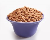 Closeup view of butterscotch chips in blue bowl — Stock Photo