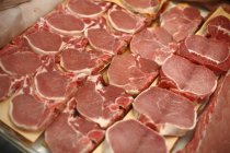 Raw Pork Chops on Display Case — Stock Photo