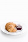 Croissant und Marmelade auf Teller — Stockfoto