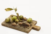 Walnuts on chopping board — Stock Photo