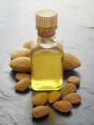 Almond oil and almonds — Stock Photo