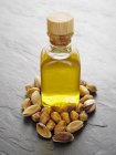 Pistachio oil and pistachios — Stock Photo