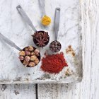 Top view of spice mix in measuring spoons and on marble board — Stock Photo