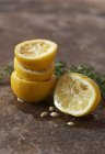 Squeezed lemon halves with rosemary — Stock Photo