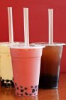 Closeup view of various types of bubble tea in plastic cups with straws — Stock Photo