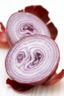 Halved red onion with skin — Stock Photo