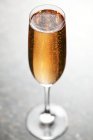 Glass of champagne on table — Stock Photo