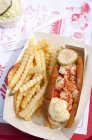 Lobster Roll Halved with French Fries over cloth on table — Stock Photo
