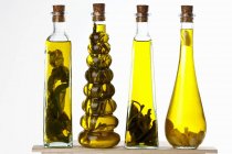 Bottles of olive oil with various aromas — Stock Photo