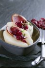 Closeup view of pears filled with smoked goose breast and dried cranberries — Stock Photo