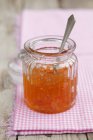Closeup view of orange marmalade in a jar — Stock Photo