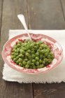 Peas with butter on textile — Stock Photo