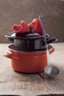 Closeup view of piled pots with lid, ladle and pot holder — Stock Photo