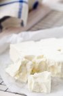 Feta crumbled on paper — Stock Photo