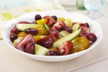 Salade de tomates et d'olives sur assiette blanche — Photo de stock
