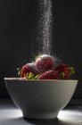 Ugar Pouring in Bowl of Strawberries — Stock Photo