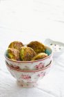 Closeup view of Latkes in bowls on white surface — Stock Photo