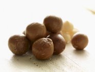 Macadamia nuts in shells — Stock Photo