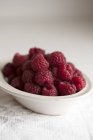Fresh Raspberries in bowl — Stock Photo