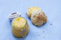 Lemon curd and halved scone — Stock Photo