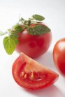 Rebanada y tomates enteros - foto de stock
