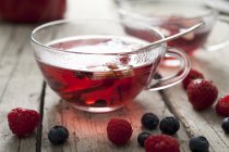Cup of tea with berries — Stock Photo