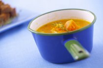Pumpkin soup in blue pot — Stock Photo