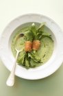 Rocket soup with salmon rolls — Stock Photo